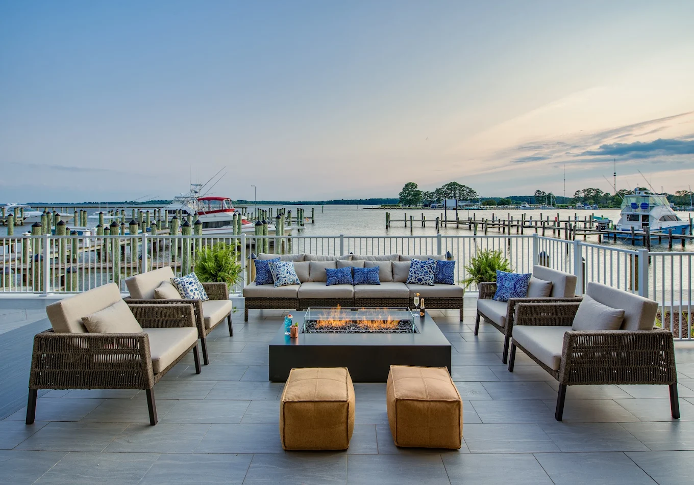 Outdoor fire pit lounge overlooking the marina at sunset